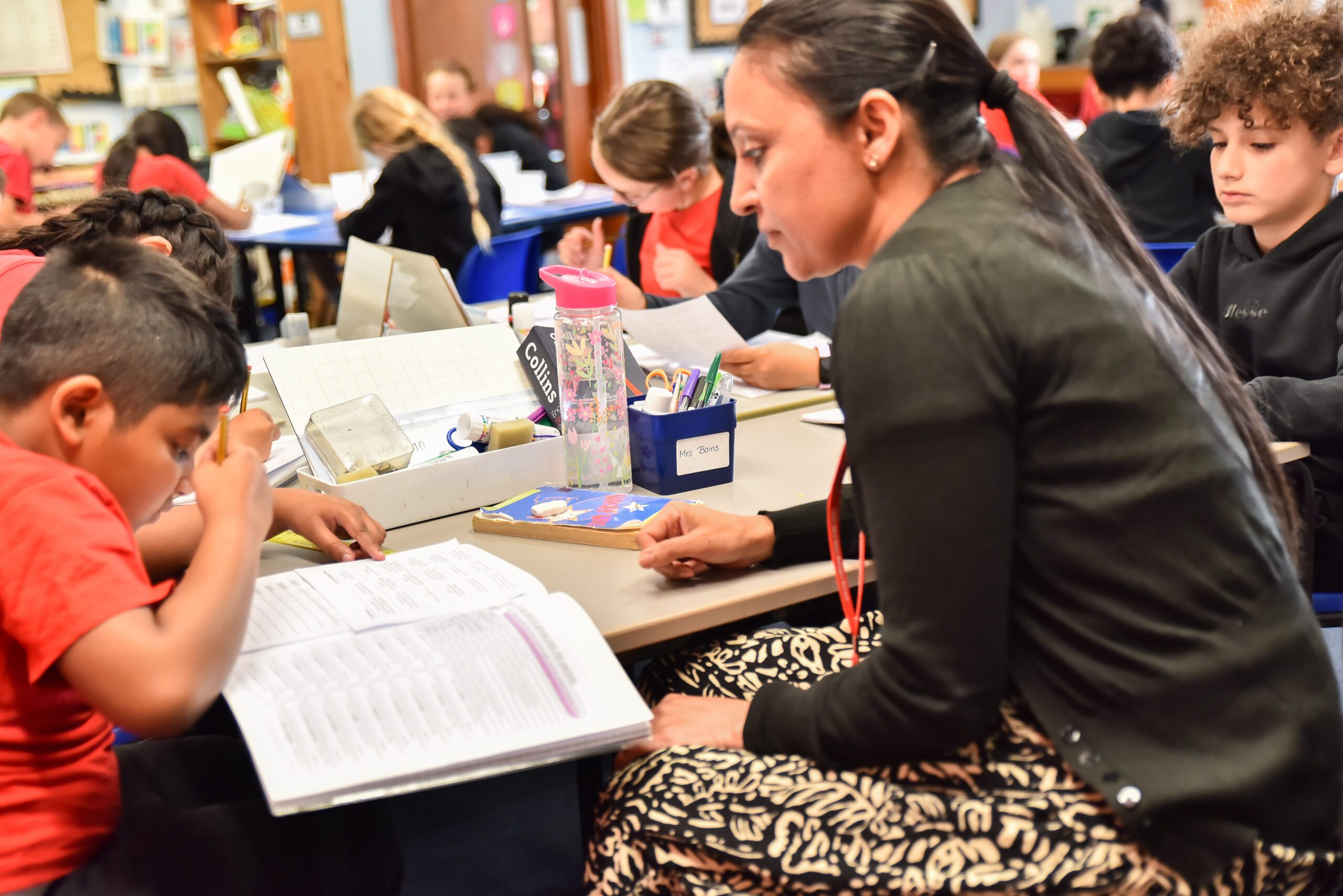 child being tutored by teacher