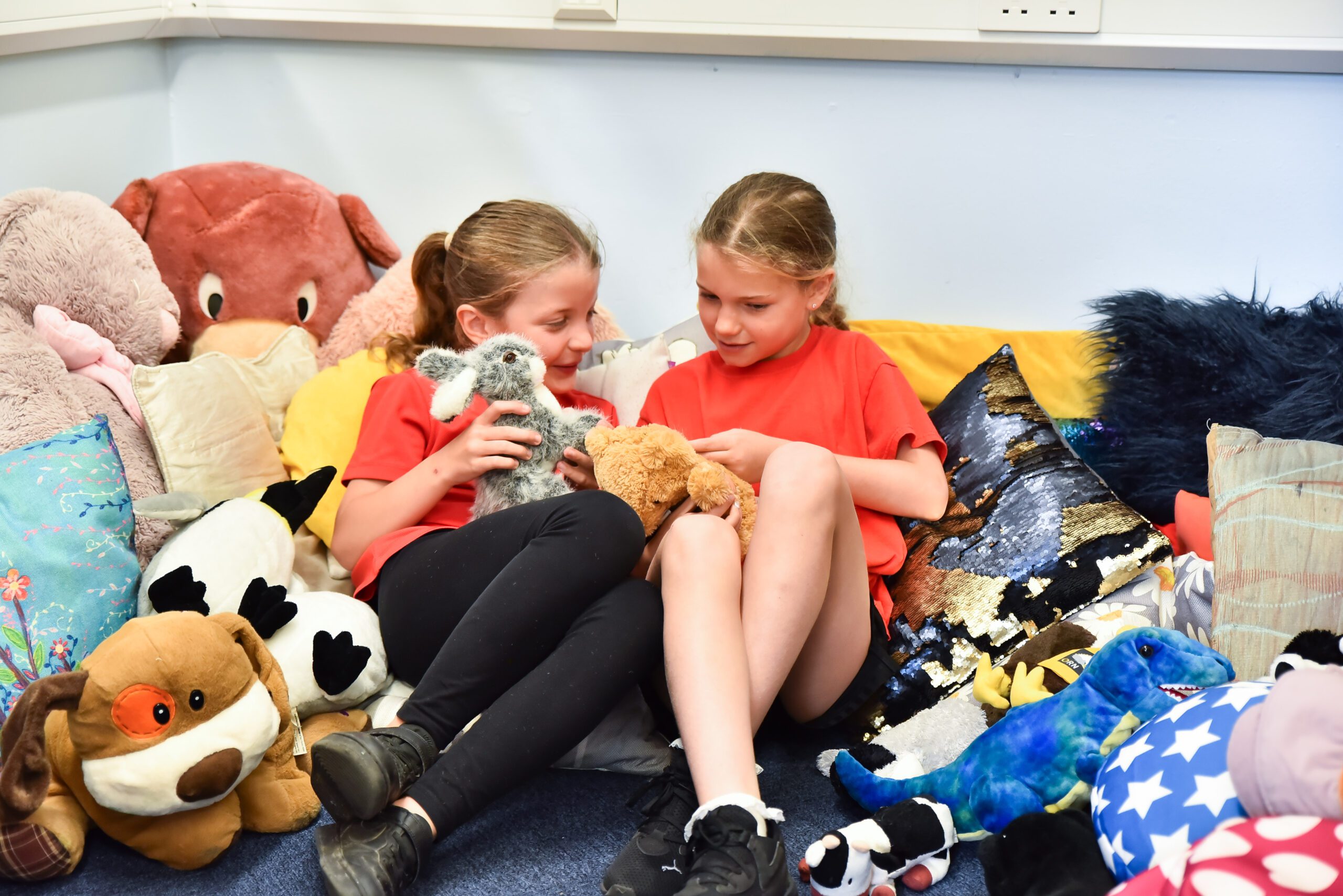 two children playing with stuffed animals